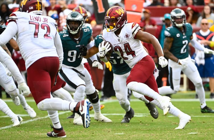 Former Washington Commanders running back Antonio Gibson (24) runs the ball against the Philadelphia Eagles.